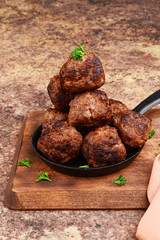 stack of meatballs on wood cutting board
