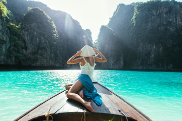 Young woman making a tour on the long tail boat, going to phi phi island