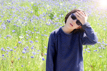 concerned child suffering from hot weather, sun halo effect