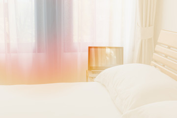 Computer notebook in modern white bedroom interior in morning light