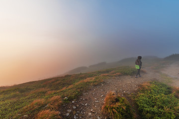 Fototapeta premium Evening on a mountain ridge with mystical fogs and scenery in the Ukrainian Carpathians.