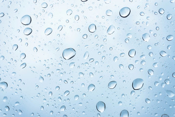 Blue Drops water drops on glass surface as background.