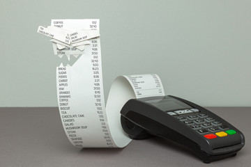 Angry paper bill. Pos terminal with paper tape on a gray background. Scary face made of paper. Big...