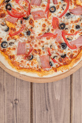Pizza capricciosa traditional italian meal from prosciutto mushrooms artichokes egg parmesan olives.