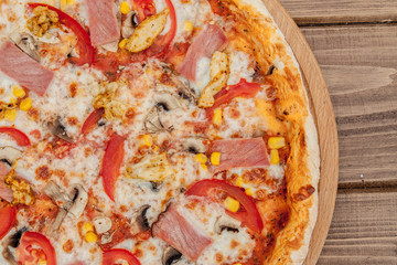 Pepperoni Pizza with Mozzarella cheese, Ham, Tomatoes, pepper, Spices . Italian pizza.