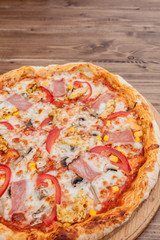 Pepperoni Pizza with Mozzarella cheese, Ham, Tomatoes, pepper, Spices . Italian pizza.