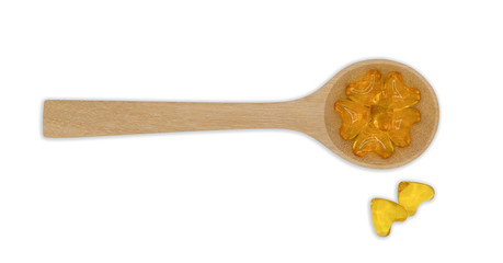 Top view vitamin pills and oil filled capsules (soft gel) in wooden spoon isolated on white background, Dietary supplement healthcare product Clipping part.