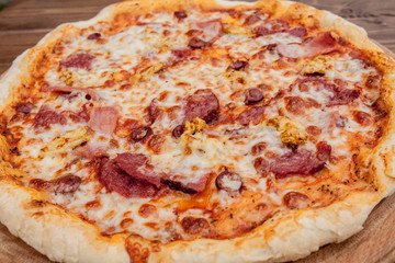 Pizza with Mozzarella cheese, salami, Tomatoes, pepper, Spices. Italian pizza
