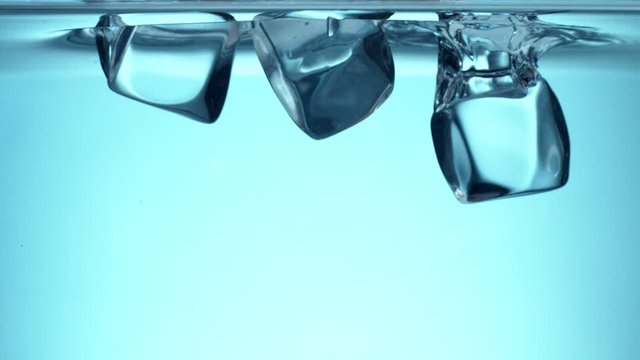 Super slow motion of falling ice cubes into water. Filmed on very high speed camera, 1000 fps.