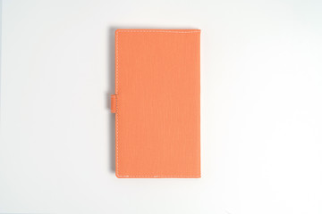top view blank orange leather diary on white desk