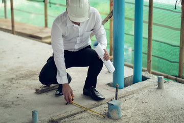 Engineer checking defect in construction site measure offset distance of sleeve of soil pvc pipe