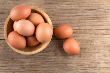Raw chicken eggs organic food for good health high protein in wooden bowl on rustic wood background