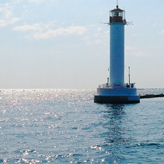 White lighthouse in the sea, view from the boat