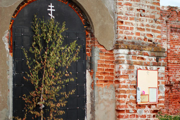The entrance to the old ruined Church. The cross of the destroyed Orthodox Church.
