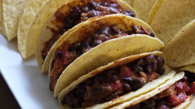 Handheld closeup view of hand made vegetarian tacos