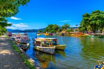 Deurstickers Embankment of historical center with boats in Paraty, Rio de Janeiro, Brazil. Paraty is a preserved Portuguese colonial and Brazilian Imperial municipality © Ekaterina Belova