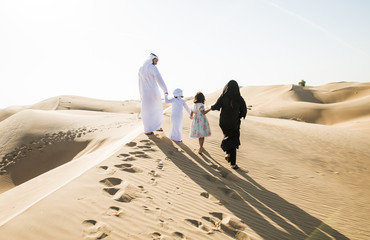 Arabian family spending a weekend in the desert, in Dubai