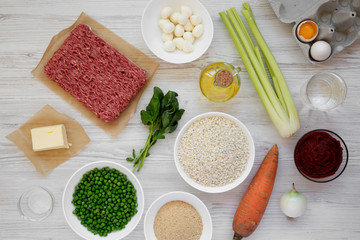 Ingredients for cooking Arancini on a white wooden background, top view. Flat lay, from above, overhead. Close-up.