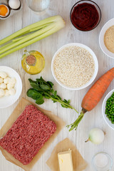 Ingredients for cooking Arancini on a white wooden table, top view. Flat lay, from above, overhead. Close-up.