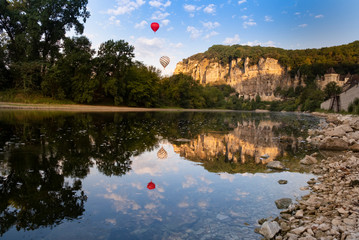 Hot air balloons at Roque Gageac, Dordogne, France. The Perigord region is famous for food and...
