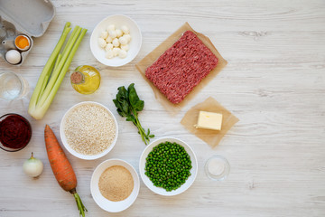Ingredients for cooking Arancini on a white wooden surface, top view. Flat lay, from above, overhead. Space for text.