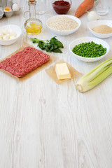 Ingredients for cooking Arancini on a white wooden background, side view. Copy space.