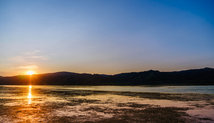 Sunset with reflection on the calm river
