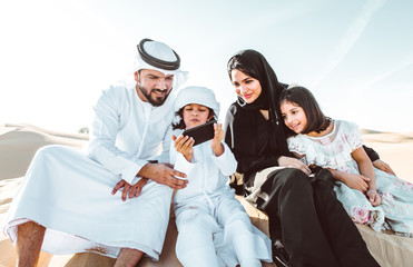 Fototapeta premium Arabian family spending a weekend in the desert, in Dubai