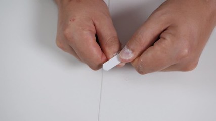Man makes manicure at home. Concept of male beauty. Manicure on male hands. Nail file in male hands