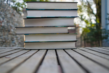 A stack of books on a street table in fine weather