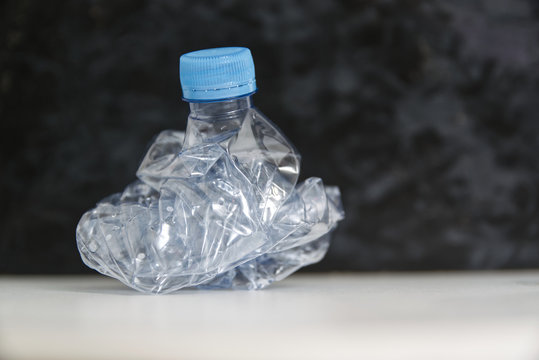 Transparent plastic bottle of water as a environmental pollution concept. Plastic containers recicling metaphor with empty copy space for Editor's text.