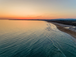 Aerial sunset seascape of Salgados beach in Albufeira, Algarve tourism destination region, Portugal.