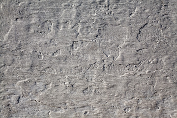Grey background of rough stucco stone wall