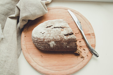 Pieces of bread on a wooden cutting board.