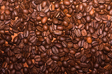 Spilled coffee beans. Top view . Warm colors.