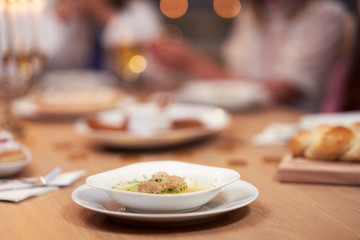 Hanukkah dinner. Family gathered around the table with traditional dishes
