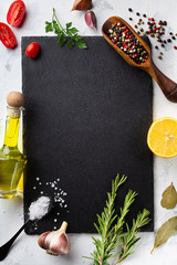 Culinary background with kitchen slate board, herbs and different spices. Empty place for menu or...