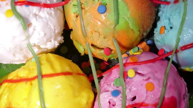 Colorful ice cream balls thaw time lapse shot