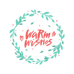 Warm wishes vector brush lettering in floral wreath. Handwritten Christmas typography print.  Hand drawn decorative design element.