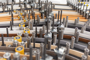 Obraz premium a close-up of a machine transporting plastic edges of different colours in one guide