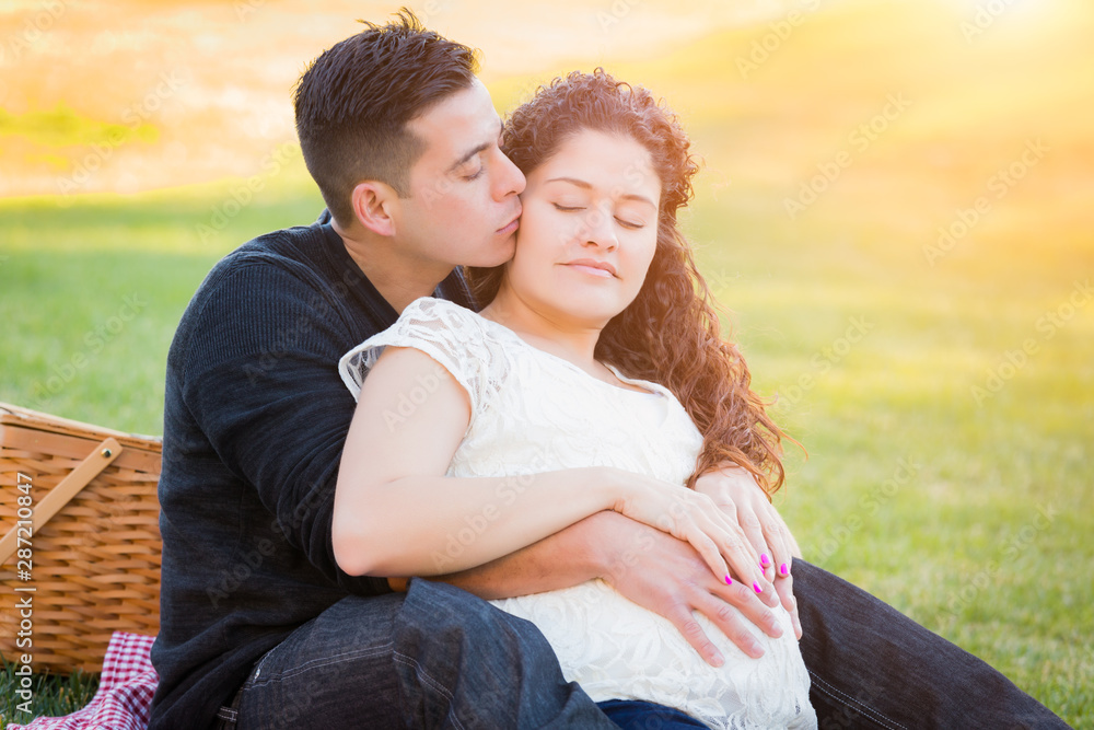 Wall mural Hispanic Pregnant Young Couple Portrait Outdoors