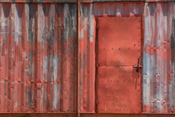 Fototapeta na wymiar The old red texture of the container with the door, Vintage background.