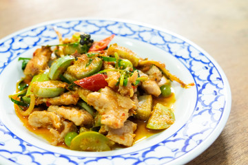 Stir-fried spicy red curry chili with pork in vintage dish. Thai local food delicious recipe.