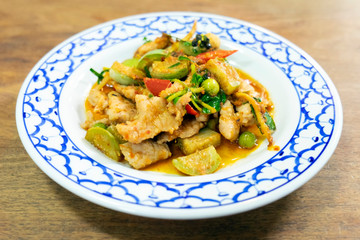 Stir-fried spicy red curry chili with pork in vintage dish. Thai local food delicious recipe.
