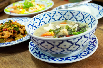 Thai spicy soup with catfish (Asian redtail catfish) in vintage bolw. Thai said Tom Yum fish. Thai food set dinner menu.