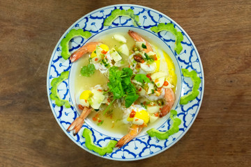 Shrimps steam spicy salad with egg and bitter melon sliced top view.