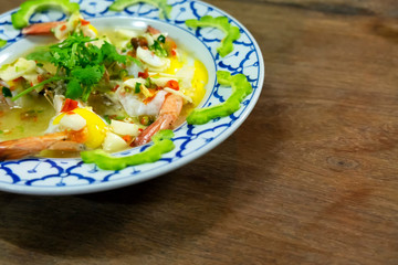 Shrimps steam spicy salad with egg and bitter melon sliced.