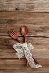 spoon and fork on a wooden background with copy space