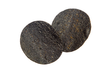 Black potato chips isolated on white
