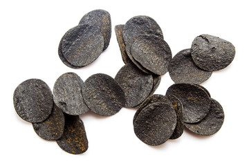 Black potato chips isolated on white